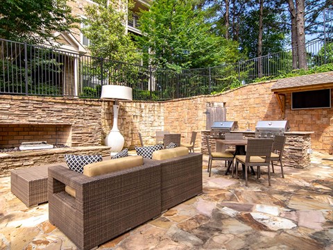 A patio with a couch, chairs, and a table.