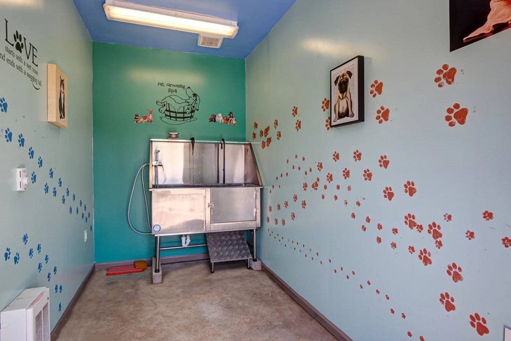 A room with a blue wall and a fridge.