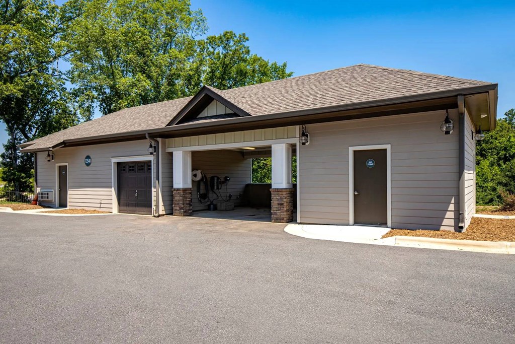 A small building with a garage door and a covered entrance.