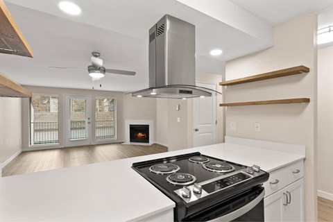 A modern kitchen with a stove top oven and a range hood.