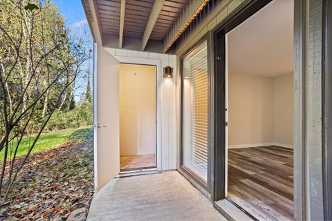 A modern house entrance with a wooden door and a glass door.
