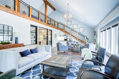 A living room with a white couch and a wooden coffee table.
