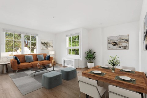 A modern living room with a wooden table set for two.