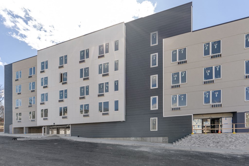 a large building with many windows and a street in front of it