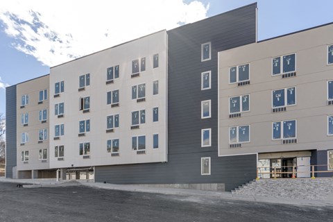 a large building with many windows and a street in front of it