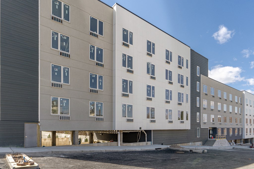 the back of a building with a street in front of it