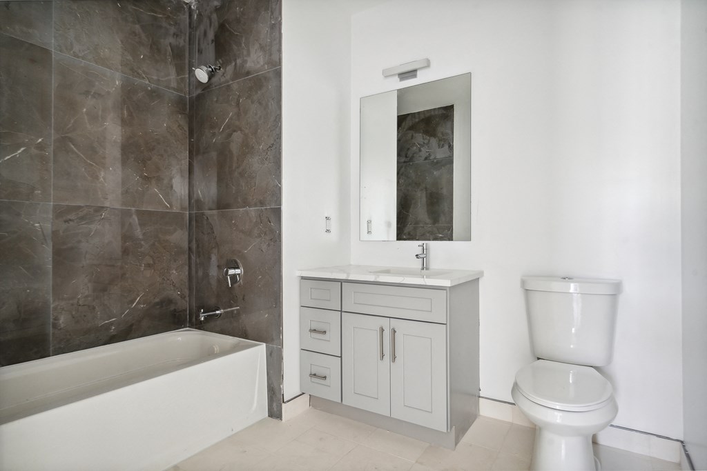 a bathroom with a toilet and a sink and a bath tub