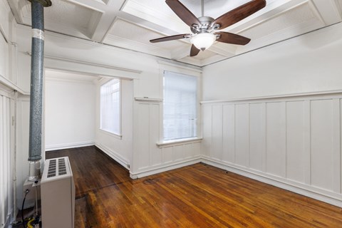 A room with a ceiling fan and a radiator on the floor at Midtown  Apartments, Portland, OR