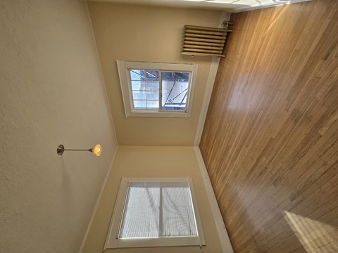 A small attic room with a skylight and a window. at Casa Del Rey Apartments, Portland, Oregon