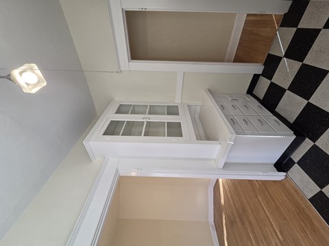 A white kitchen with a checkered floor at Casa Del Rey Apartments, Apartments, Portland, OR