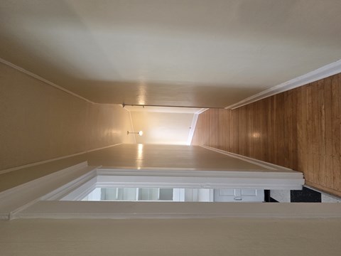 A long, narrow room with wooden walls and a skylight in the middle. at Casa Del Rey Apartments, Portland, OR, 97209