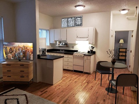 an open kitchen and dining area with a table and chairs