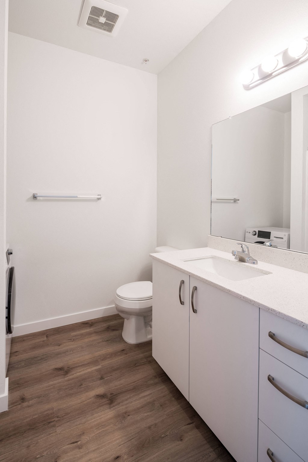 a bathroom with a toilet and a sink and a mirror
