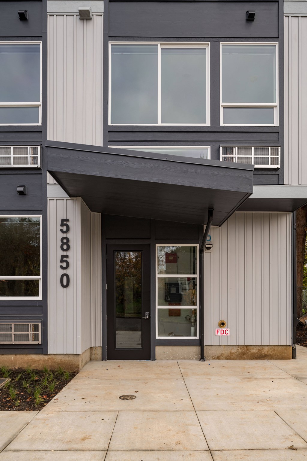 the front of a building with a door and windows