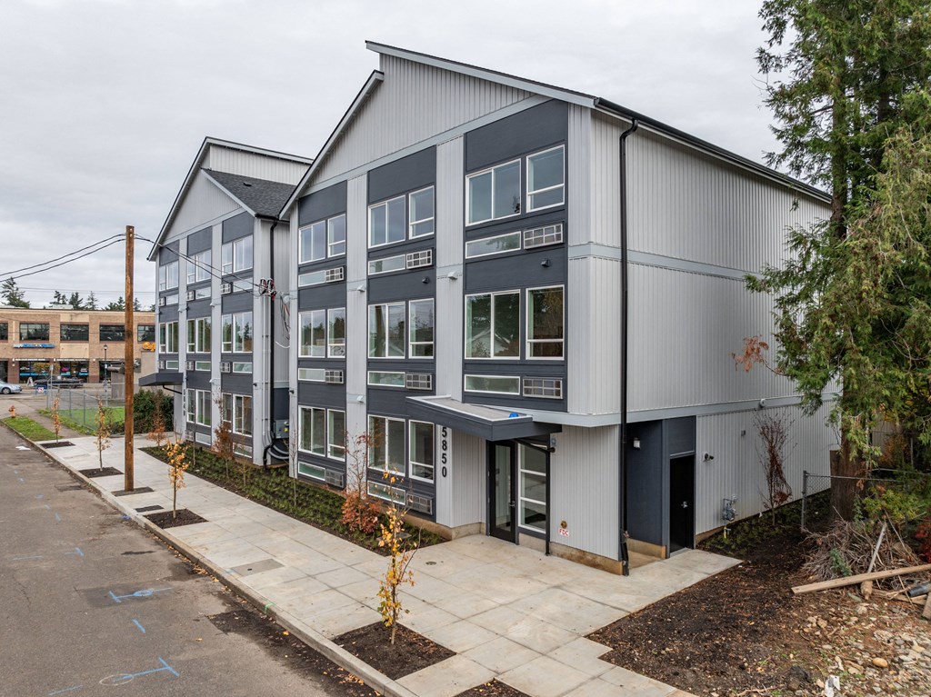 a building with a sidewalk in front of it