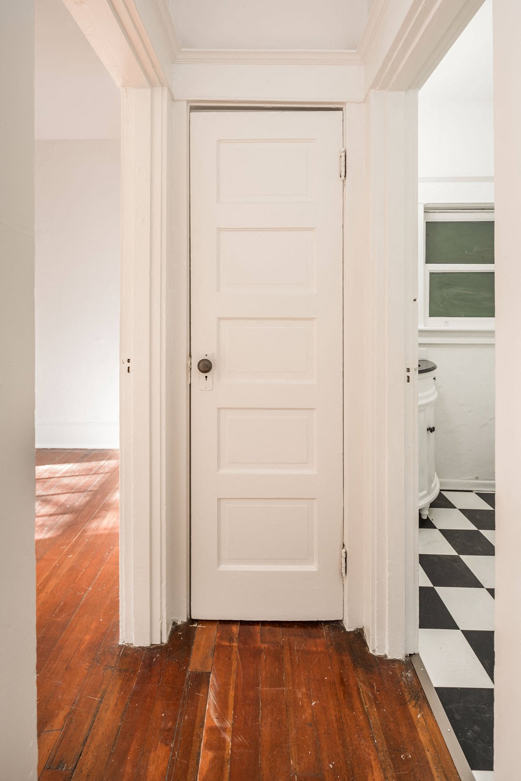 a white door in a room with wood floors