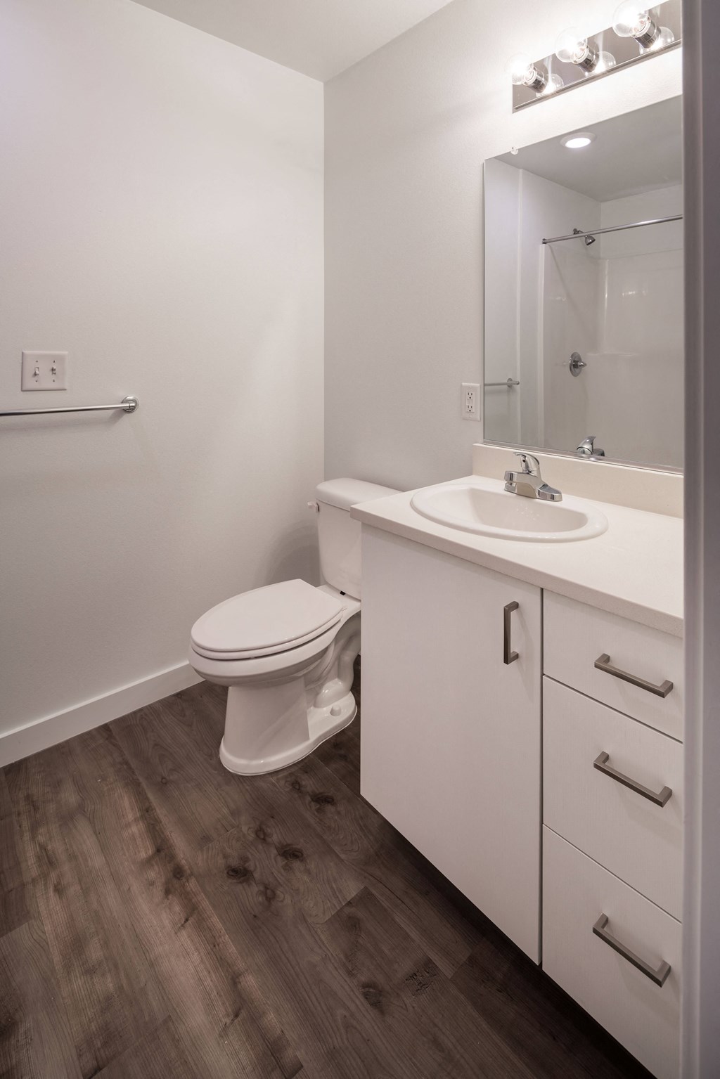 a bathroom with a toilet and a sink and a mirror