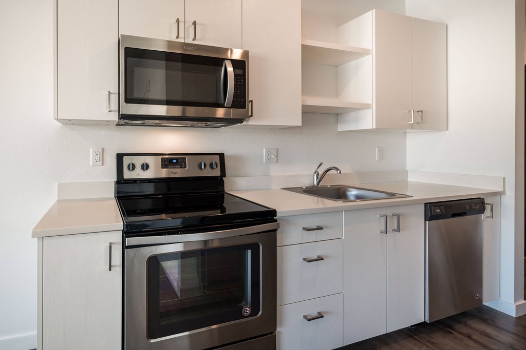 a kitchen with stainless steel appliances and white cabinets