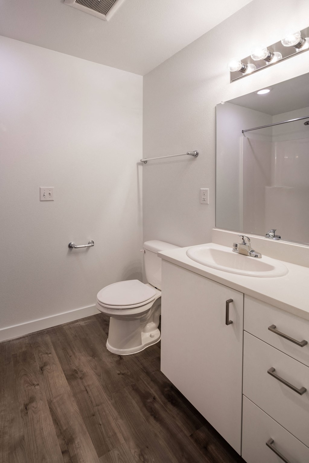 a bathroom with a toilet and a sink and a mirror