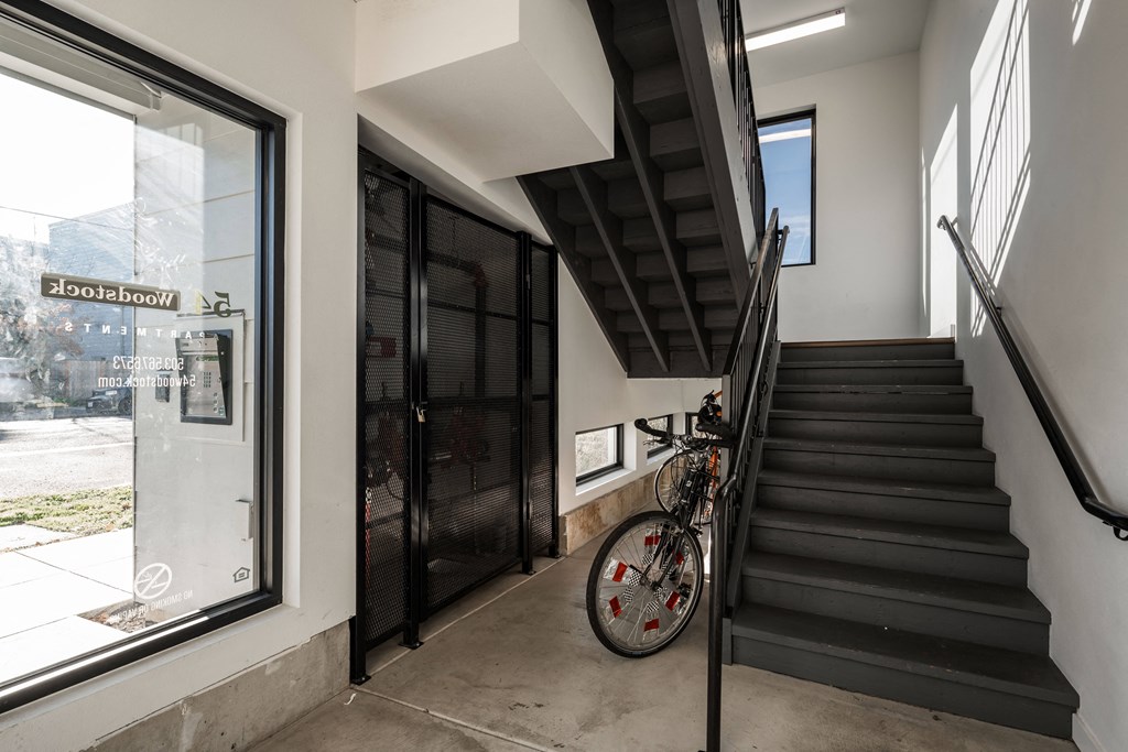 a staircase with a bike next to a stairwell and a glass door
