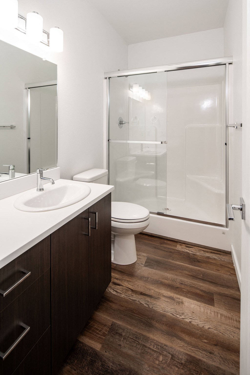a bathroom with a toilet sink and shower