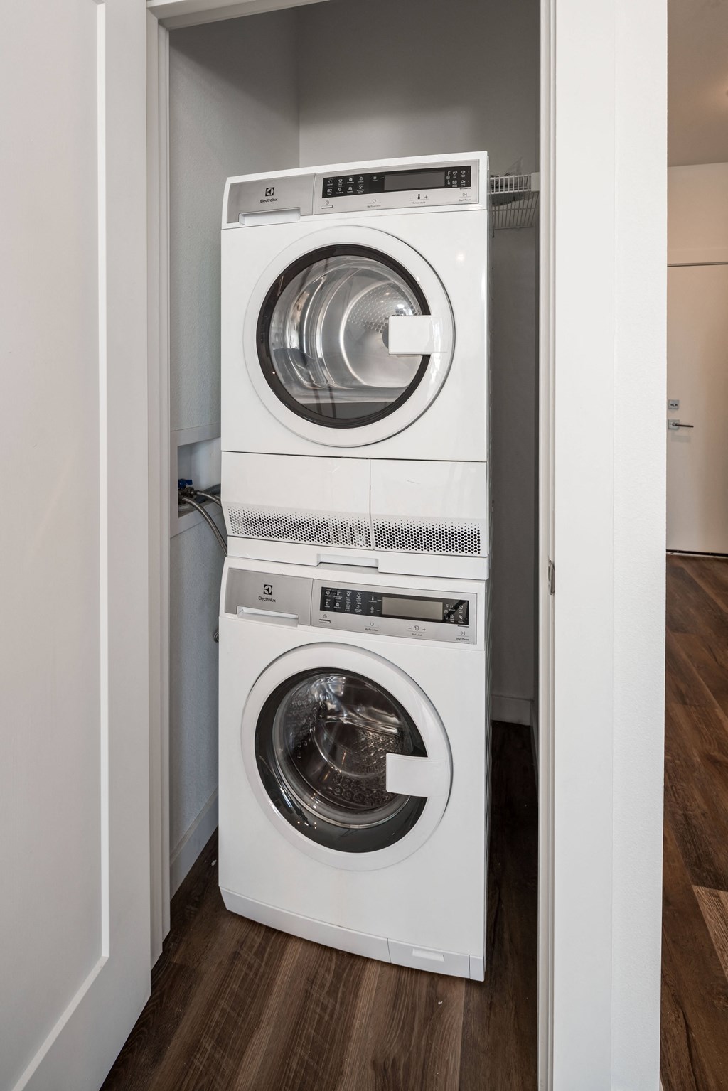 a front loading washer and dryer in a small laundry room