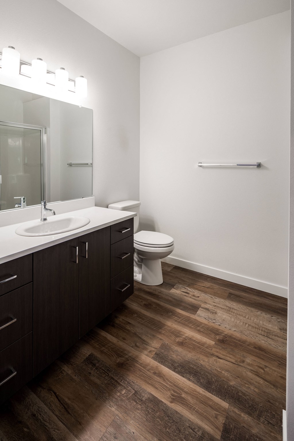 an empty bathroom with a toilet sink and mirror