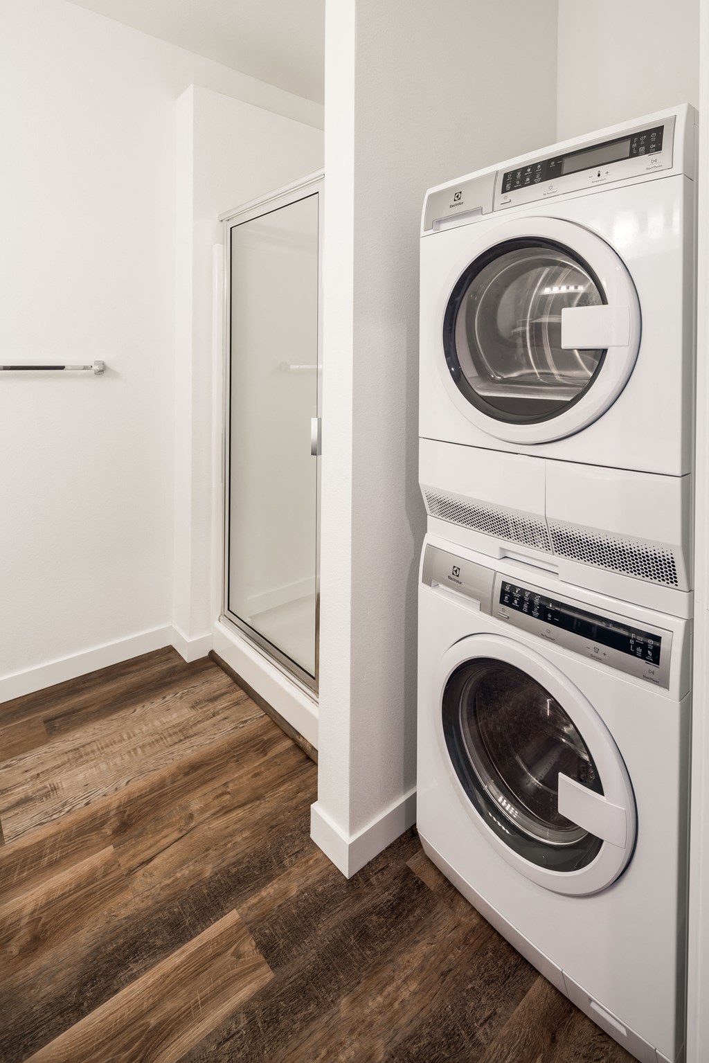 a washer and dryer in a laundry room with a glass door