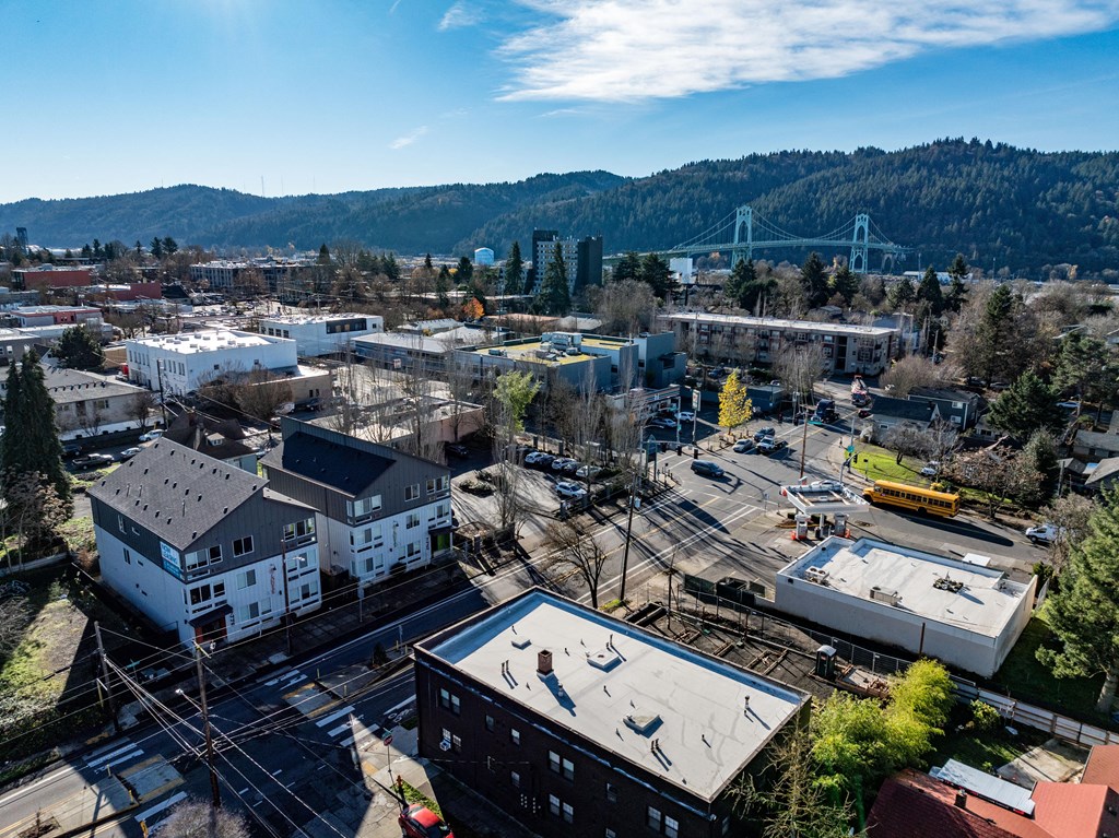 arial view of a city with a bridge in the background