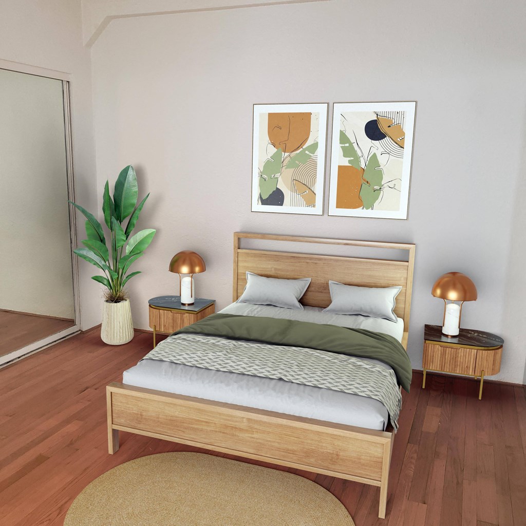 a bedroom with a bed and two paintings on the wall