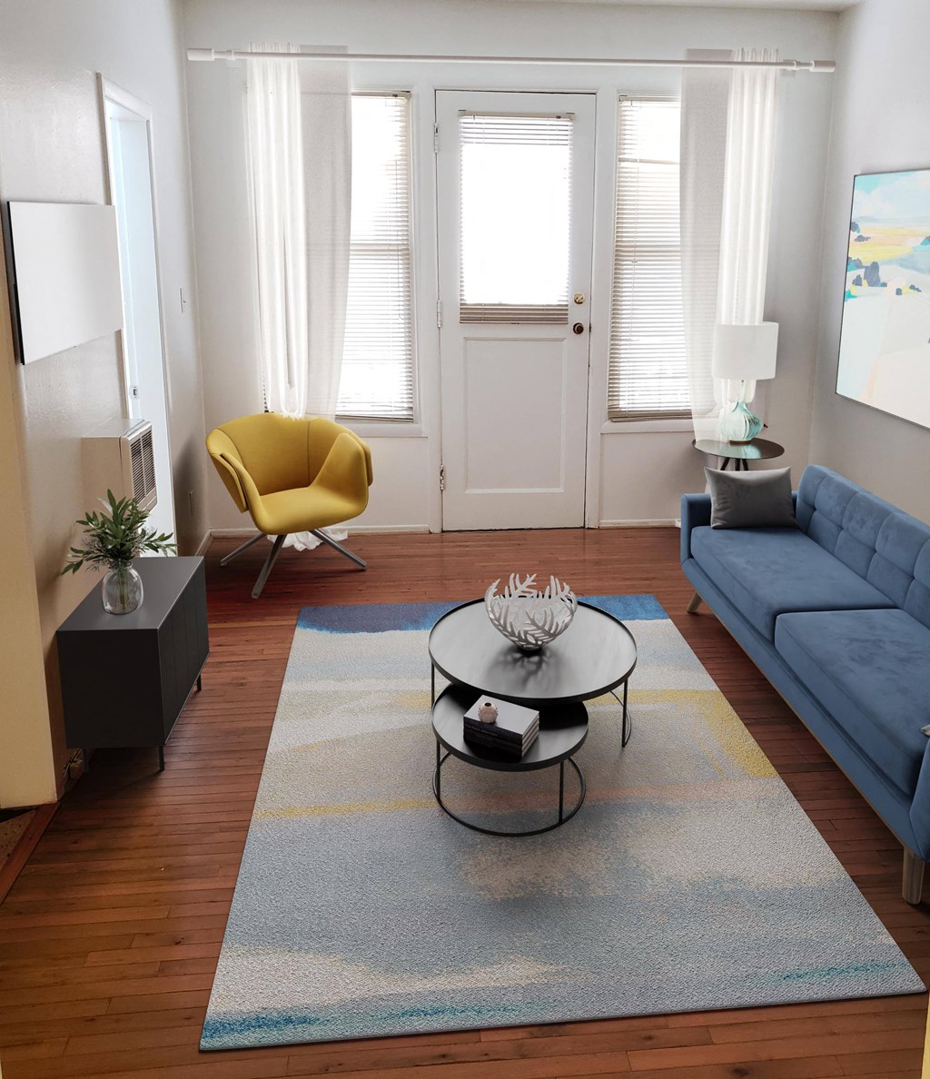 a living room with a blue couch and a yellow chair
