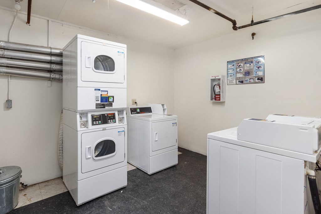 a laundry room with washing machines and dryers