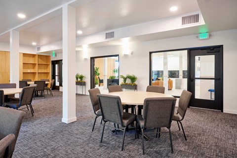 A conference room with a long table and chairs.