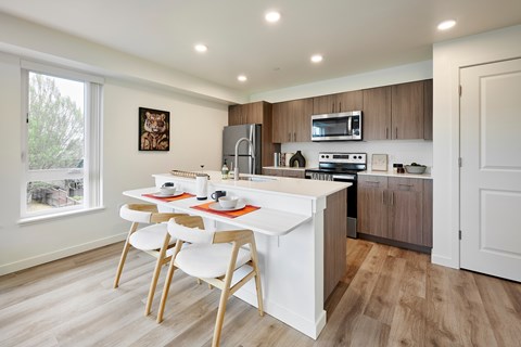 A kitchen with a white table and chairs.
