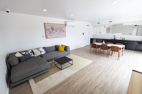 a living room and dining room with a couch and a table at Analog PDX Apartments, Portland, OR