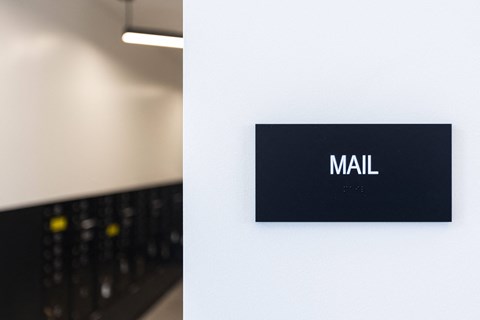 a sign for a mall on a white wall at Analog PDX Apartments, Oregon 97227