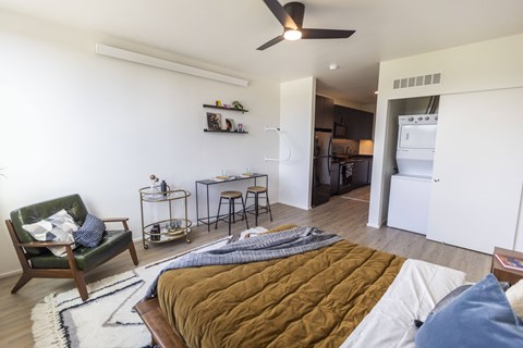 a bedroom and living room with a bed and a kitchen at Analog PDX Apartments, Oregon