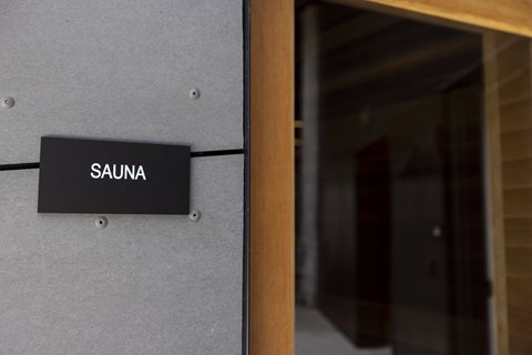 a sign on a building that reads sauna at Analog PDX Apartments, Portland