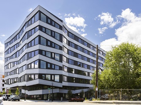 an office building on a city street with a blue sky at Analog PDX, Oregon