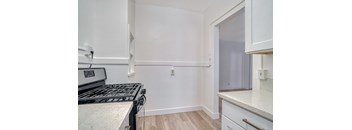 A kitchen with a stove top oven and a counter top at Clay & Tiffany, Portland, 97201
