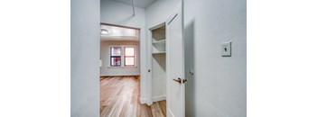 A white door with a shelf and a light switch on the wall at Clay & Tiffany, Portland, 97201