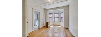 A room with wooden floors and white walls.