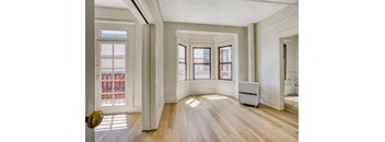 A room with wooden floors and white walls.