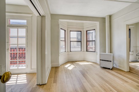 A room with wooden floors and white walls.