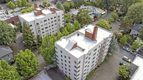an aerial view of a white building with a church on top of it