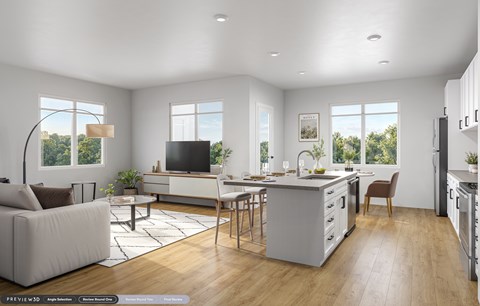 A modern kitchen with a dining table and chairs, a sofa, and a television.
