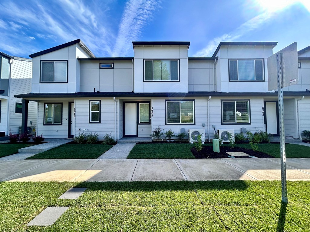 front of a large office building with cars parked outside