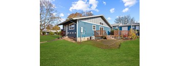 Blue house with a grey roof at Garden Villa Apartments, Portland, 97266