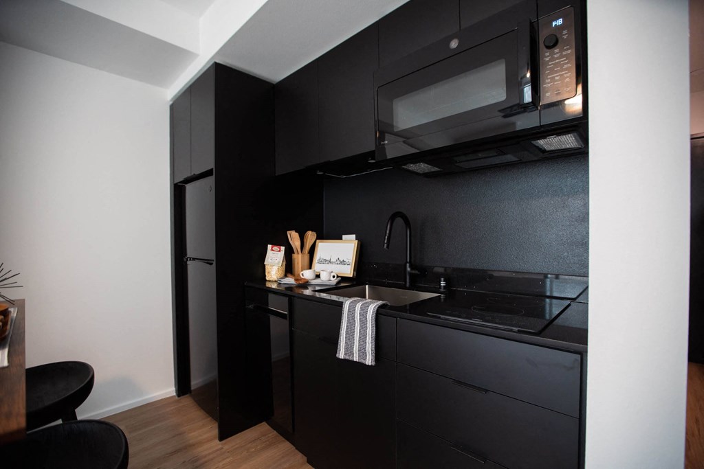 a small kitchen with a sink and a microwave a small kitchen with a sink and a microwave at Analog Tacoma, Washington