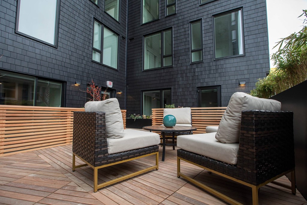 a patio with chairs and a table in front of a building at Analog Tacoma, Tacoma